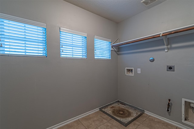 washroom featuring washer hookup, light tile patterned floors, gas dryer hookup, and hookup for an electric dryer