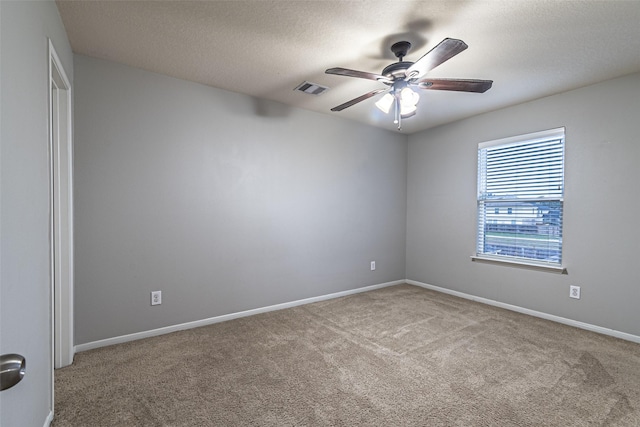 carpeted empty room featuring a textured ceiling