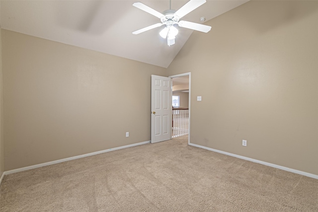 spare room with light carpet, ceiling fan, and high vaulted ceiling