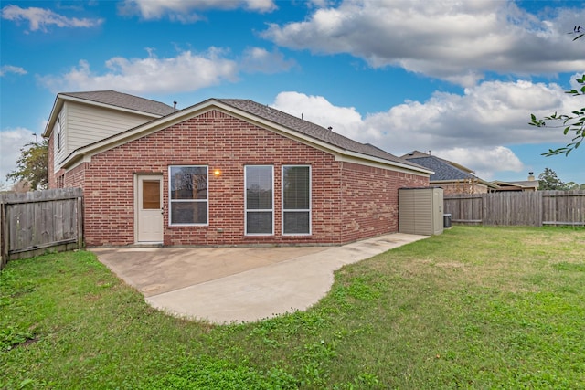 rear view of property with a patio area and a lawn