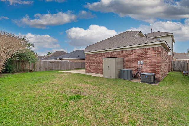 view of yard featuring central air condition unit and a patio area