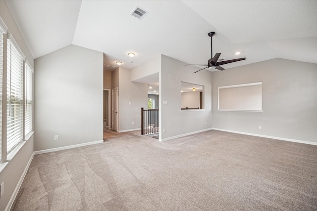 unfurnished living room featuring ceiling fan, light colored carpet, and lofted ceiling