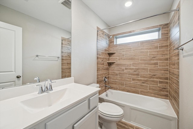 full bathroom featuring vanity, toilet, and tiled shower / bath