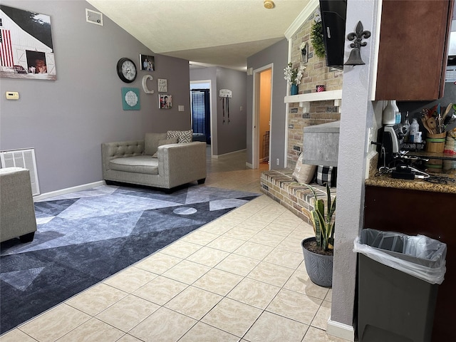 tiled living room with a fireplace and vaulted ceiling