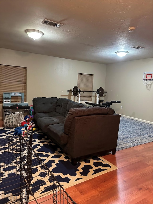 living room with hardwood / wood-style flooring and a textured ceiling