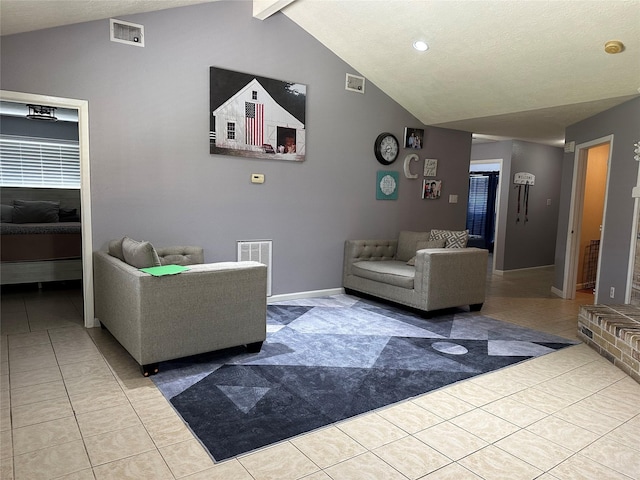 living room featuring a fireplace, lofted ceiling with beams, and light tile patterned flooring