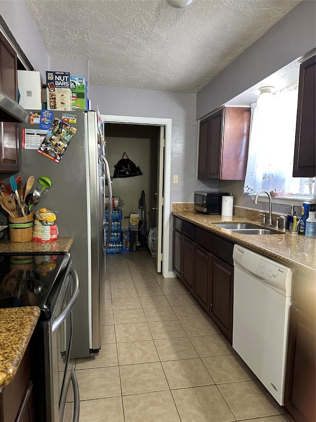 kitchen with sink, stainless steel appliances, and a textured ceiling