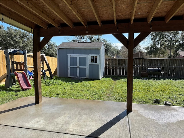 view of patio / terrace with a playground and a shed