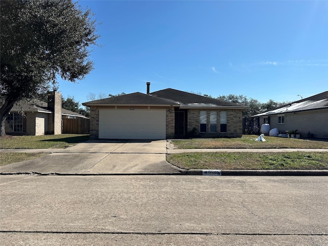 ranch-style home with a front yard and a garage