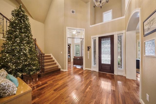 foyer featuring hardwood / wood-style flooring and a high ceiling