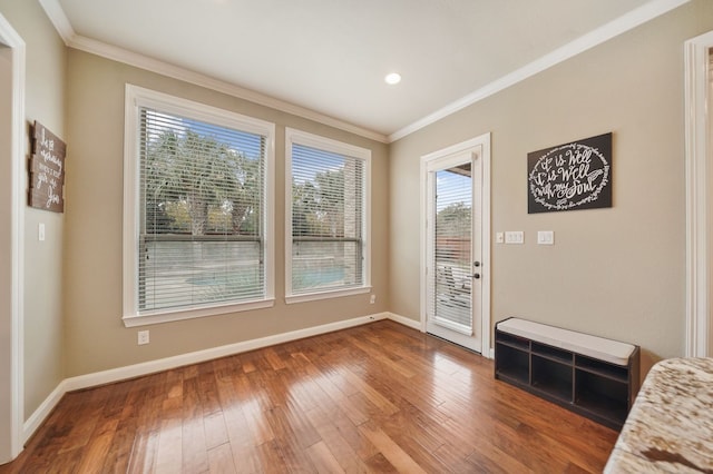 doorway to outside with wood-type flooring and ornamental molding