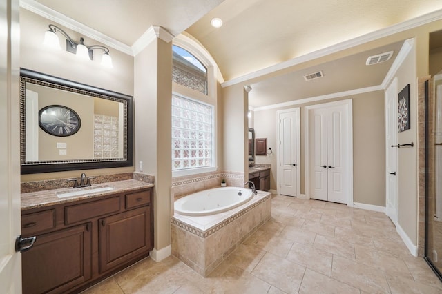 bathroom with vanity, ornamental molding, and a relaxing tiled tub