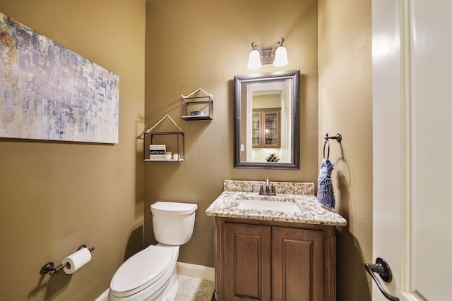 bathroom with toilet and vanity