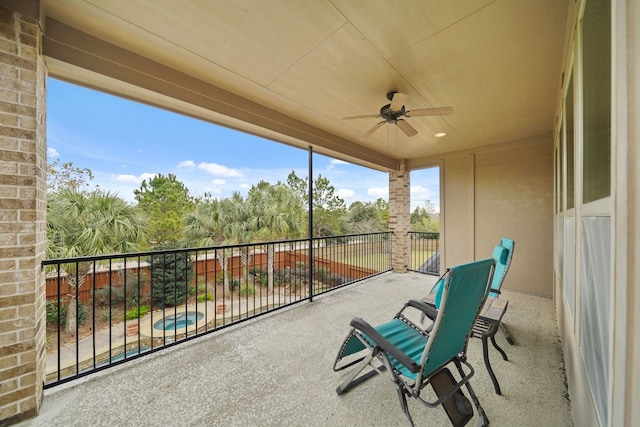 exterior space with ceiling fan and a balcony