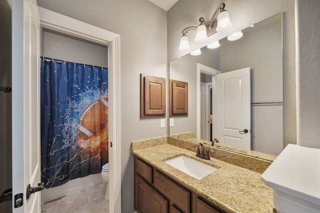 bathroom with vanity, toilet, curtained shower, and tile patterned flooring