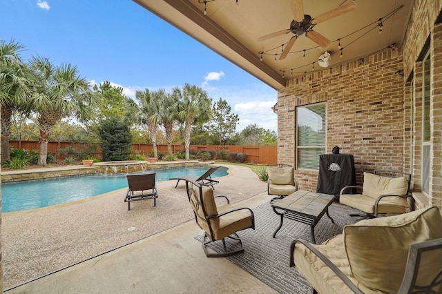 view of patio / terrace featuring ceiling fan and a swimming pool with hot tub