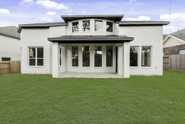 back of house featuring a patio and a lawn