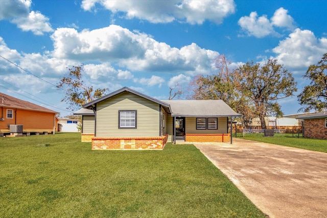 view of front of house featuring a front lawn, central AC, and a carport