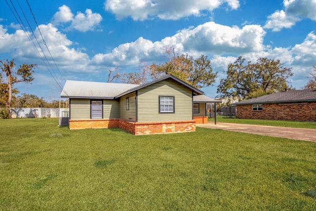 view of front of property with a front lawn and central air condition unit