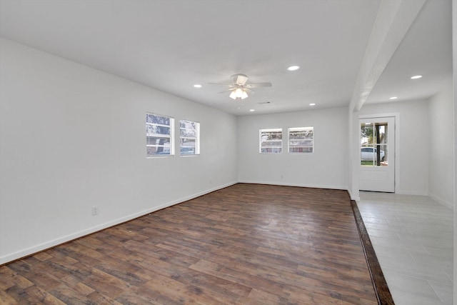 spare room with ceiling fan and dark hardwood / wood-style floors