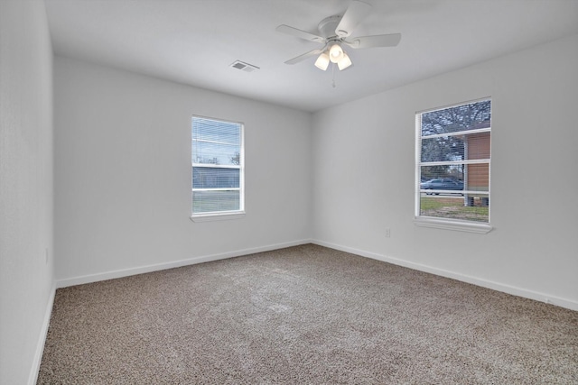 empty room featuring ceiling fan and carpet floors