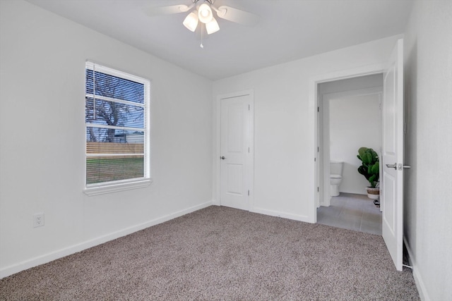 unfurnished room with ceiling fan and light carpet