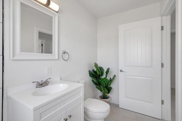 bathroom featuring toilet, tile patterned flooring, and vanity