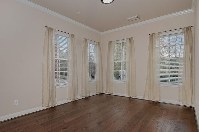 spare room featuring dark wood-type flooring and crown molding