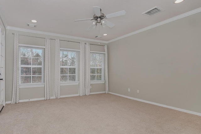 carpeted spare room with ceiling fan and ornamental molding