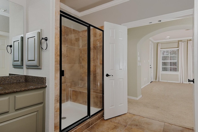 bathroom featuring walk in shower, vanity, tile patterned floors, and ornamental molding