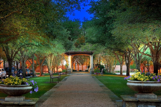 view of community with a yard and a pergola