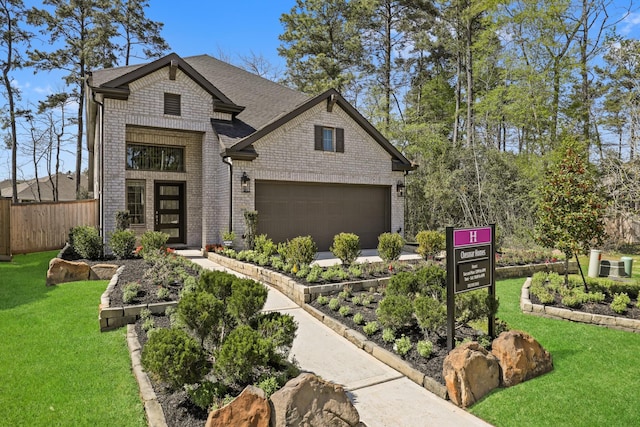 view of front facade with a garage and a front lawn