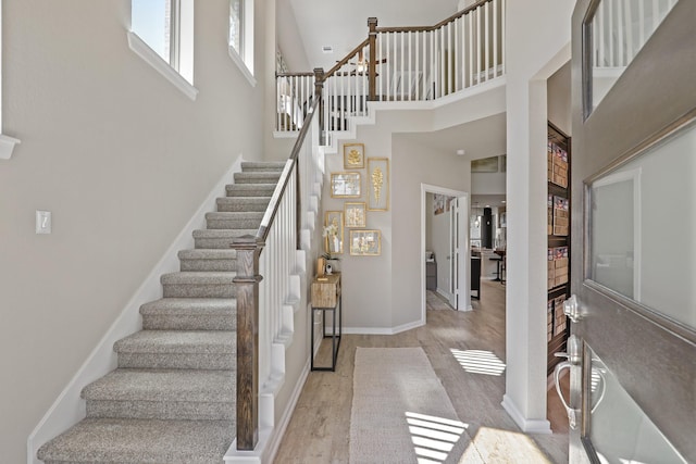 entrance foyer with light hardwood / wood-style floors and a high ceiling