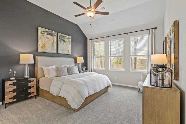 carpeted bedroom with ceiling fan and vaulted ceiling