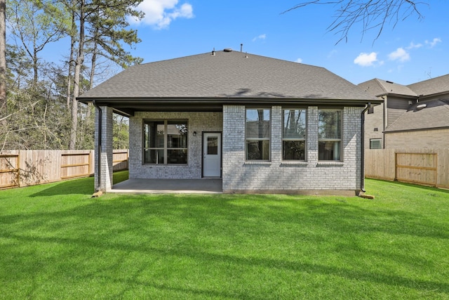 back of house featuring a lawn and a patio