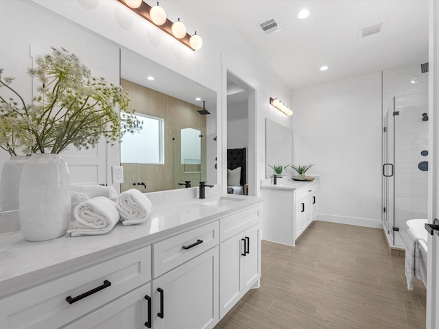 bathroom with walk in shower and vanity