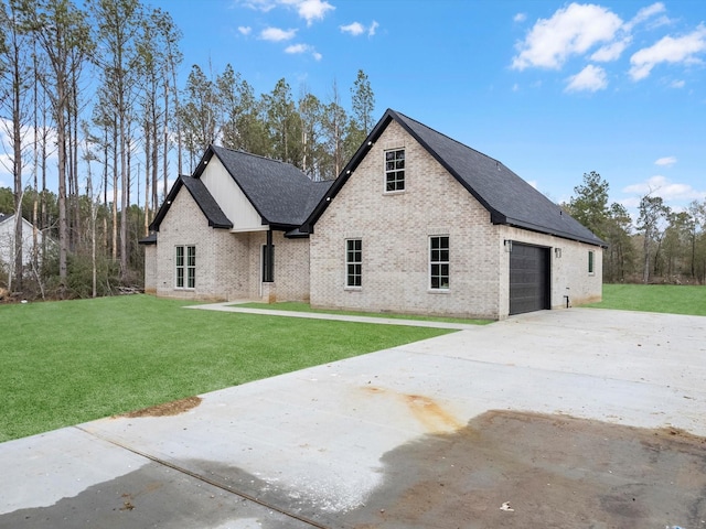 french country style house featuring a garage and a front lawn