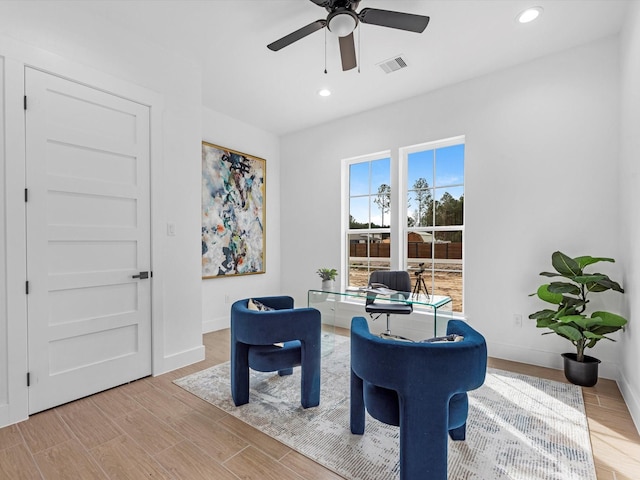 living area featuring ceiling fan