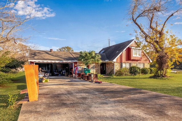 view of side of property with a garage and a lawn