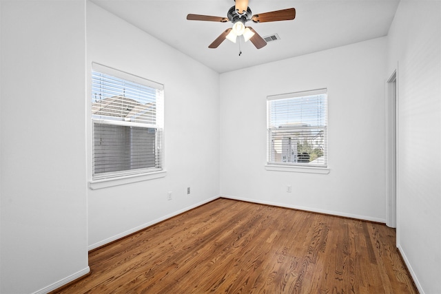 spare room featuring ceiling fan, plenty of natural light, and wood-type flooring