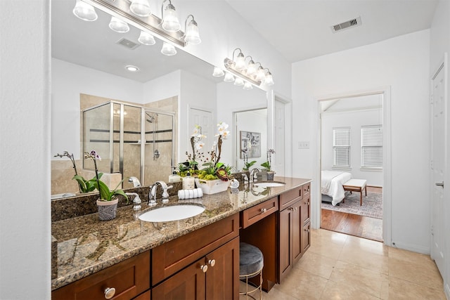 bathroom featuring vanity, an enclosed shower, and tile patterned flooring