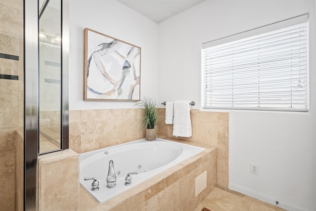 bathroom featuring tile patterned flooring and tiled tub