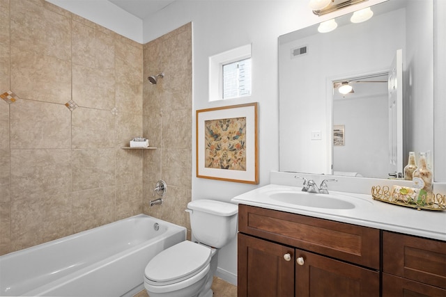 full bathroom featuring vanity, toilet, and tiled shower / bath