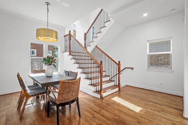 dining space featuring crown molding and hardwood / wood-style floors