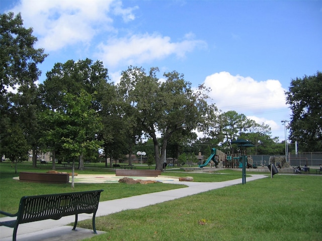 surrounding community with a yard and a playground