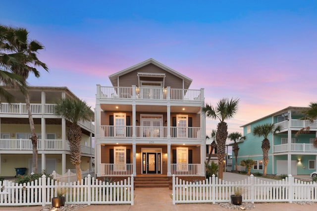 beach home featuring a balcony and covered porch