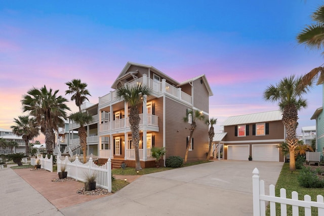 view of front of home with a balcony and a garage