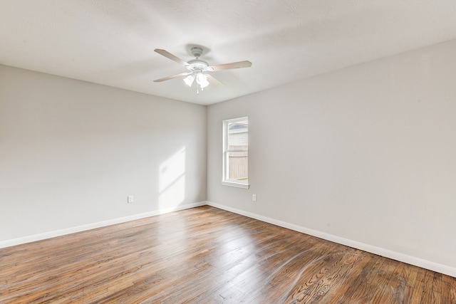 spare room with ceiling fan and hardwood / wood-style floors