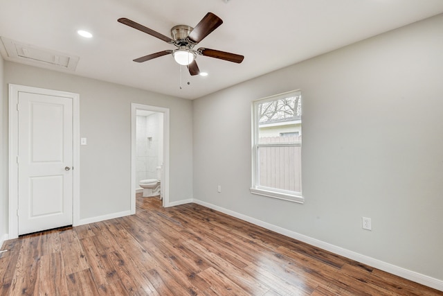 unfurnished bedroom featuring ceiling fan, hardwood / wood-style floors, and ensuite bath