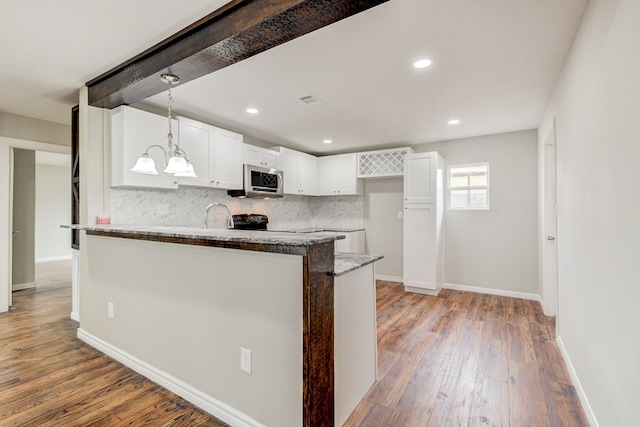 kitchen with white cabinets, decorative light fixtures, tasteful backsplash, light hardwood / wood-style floors, and stone countertops